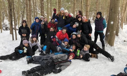 A picture of education award winner Anne Corkery with her classroom in the outdoors