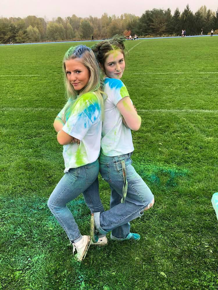 Students posing with powder paint in hair and on clothing.