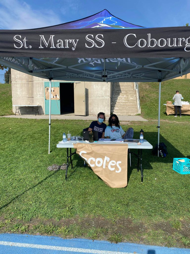 Students sitting at competition scores table.