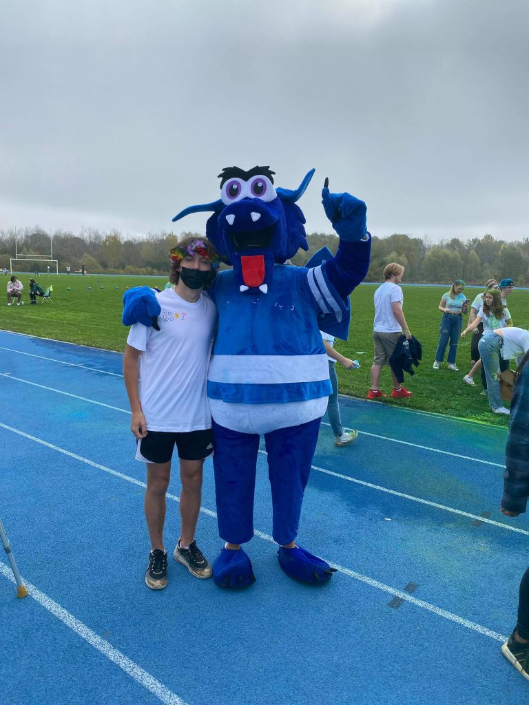 Student posing with St. Mary mascot.