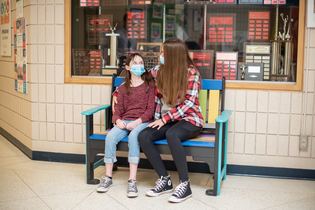 Photo of Shea and Aishling on bench dedicated to Cormack.