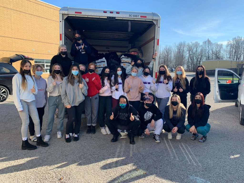 Photo of Holy Trinity students in front of cube truck.