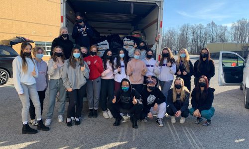 Photo of Holy Trinity students in front of cube truck.