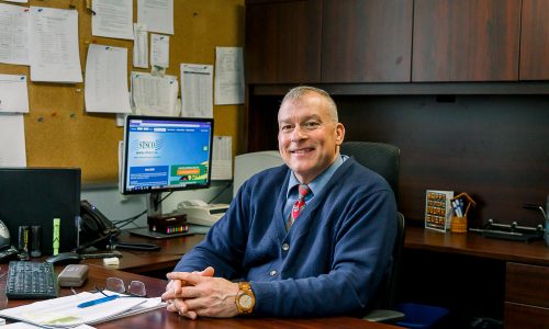 Picture of man sitting at his desk