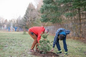 Ian Kruis with student Zachary assessing newly planted tree.