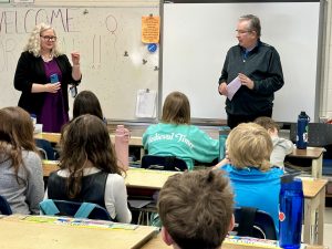Visitors talking to a classroom 