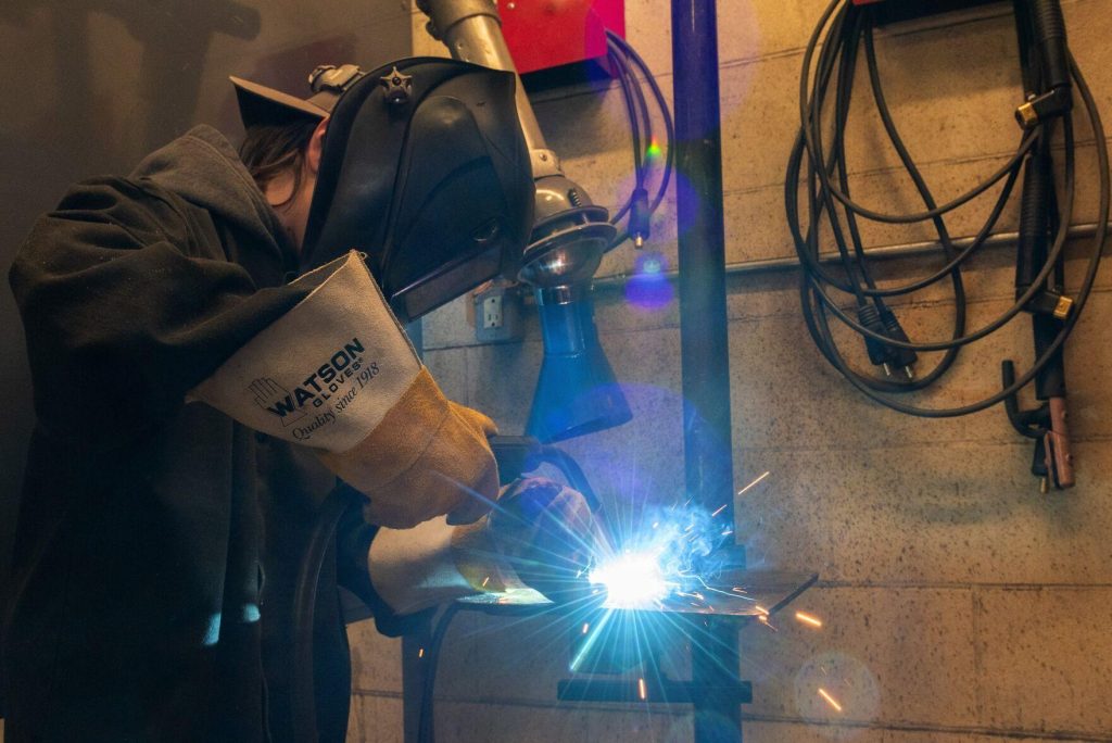 Sparks fly as student CJ Vokes-Greenly works on her project during the Mind Over Matter Welding summer camp with Indigenous youth at St. Peter Secondary School Thursday.