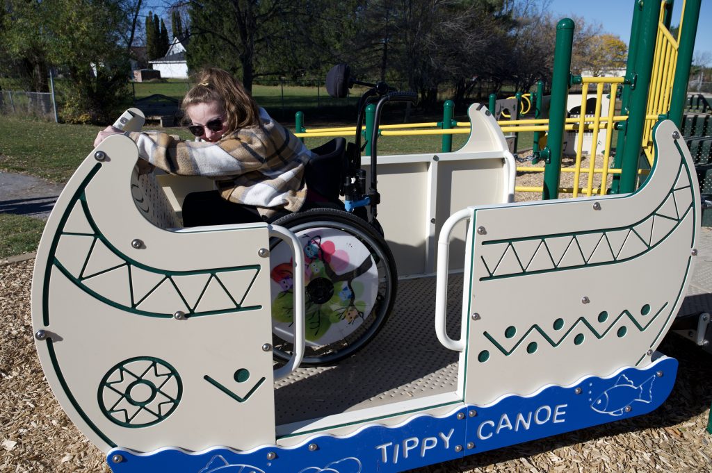 Child playing on new accessible play structure.