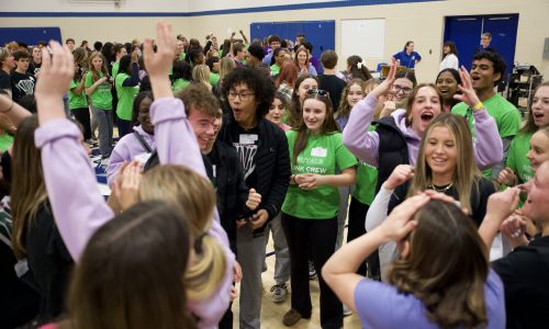Group of students playing the game Rock, Paper, Scissors