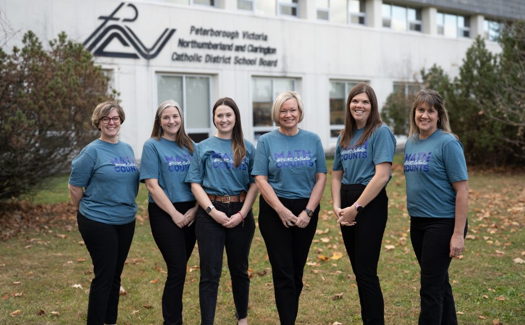 Six member math team poses in-front of building.