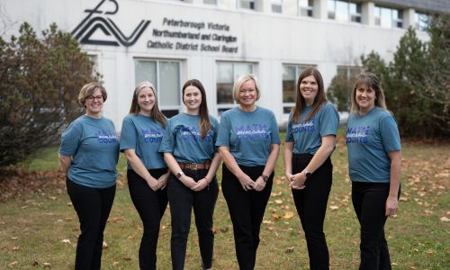 Six member math team poses in-front of building.