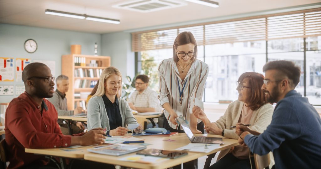 Adults sitting around the table in a working group.