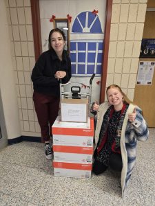 Two students shipping boxes of Christmas cards.