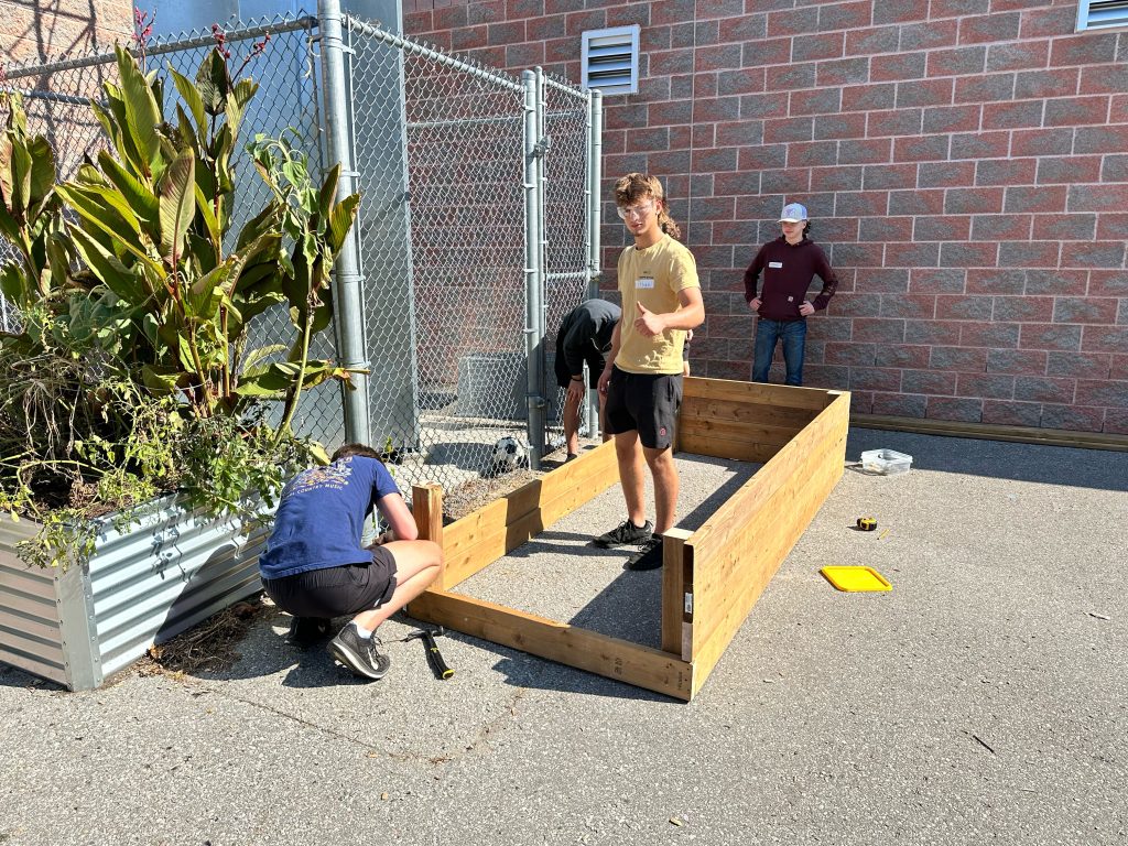Students building a garden in a schoolyard.