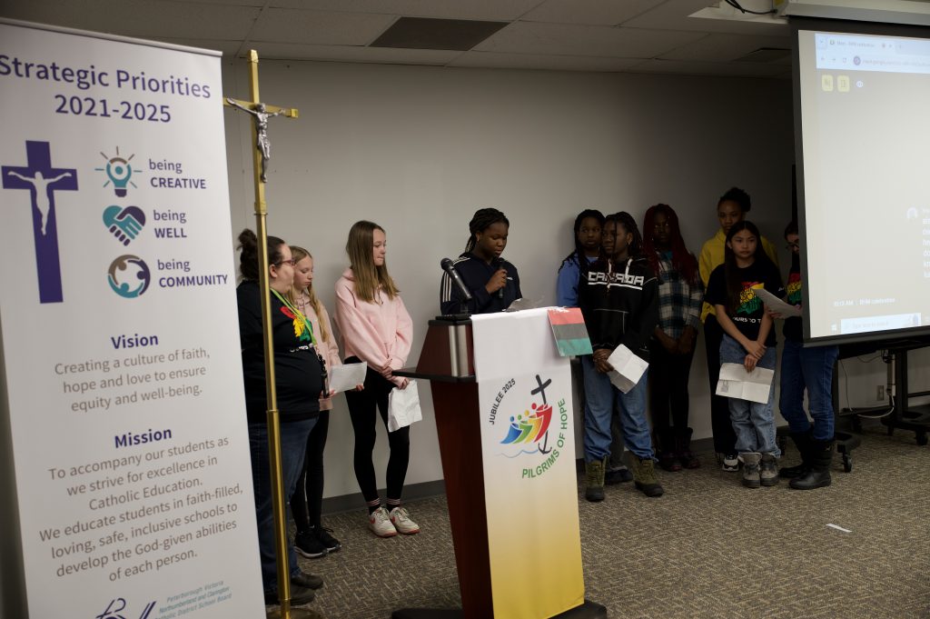 Students read poems at ceremony.