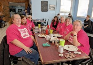 Group of adults wearing pink for Pink Shirt Day