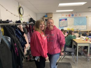 Two people posing for photos wearing pink for Pink Shirt Day