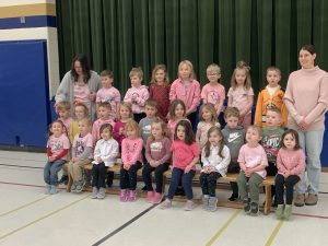 Group of students posing in pink.