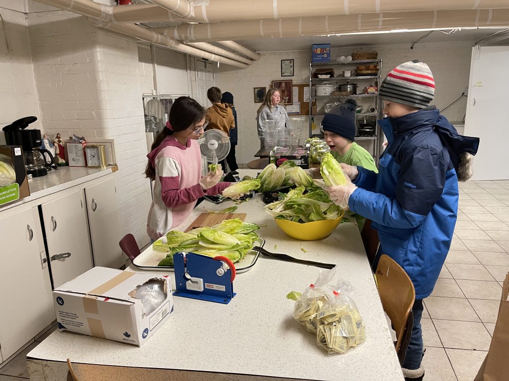 Students helping sort fresh produce at food bank