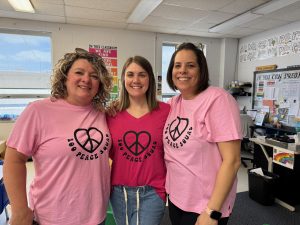 Three women wearing pink for Pink Shirt Day