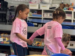 Two students wearing pink for Pink Shirt Day