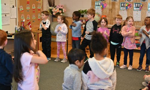 Students sing and perform during a presentation.