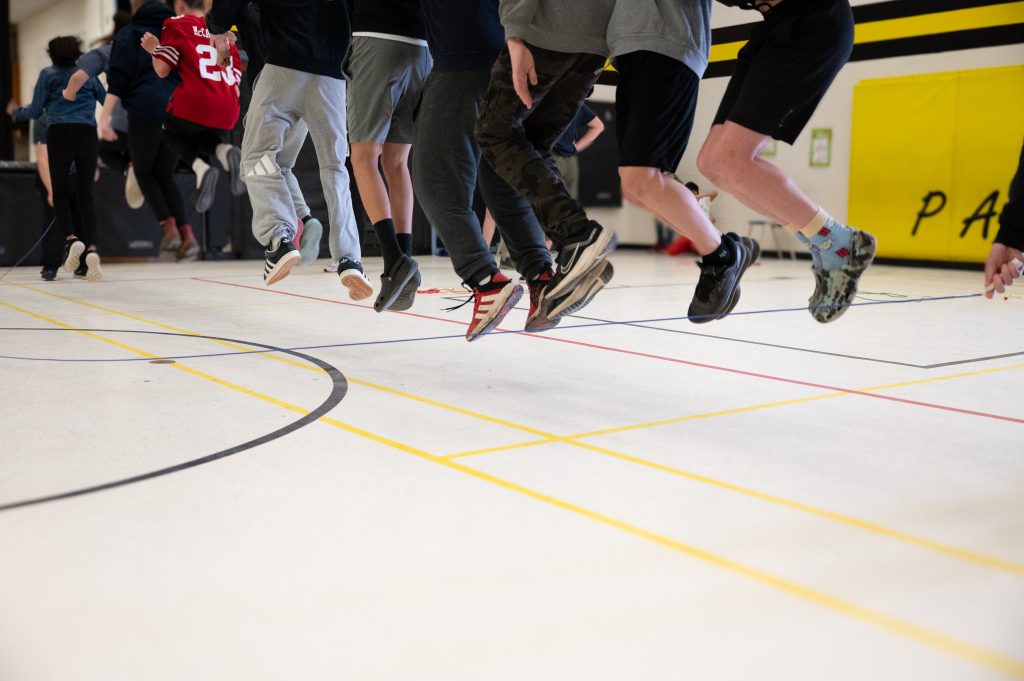 Group of children jumping rope together.