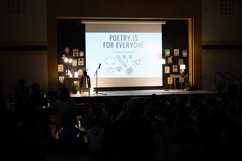 Poetry assembly in a school gymnasium.