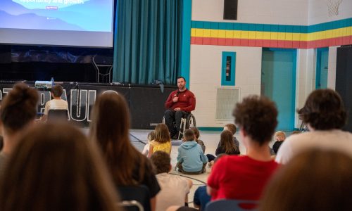 Paralympic athlete speaks at a school assembly.