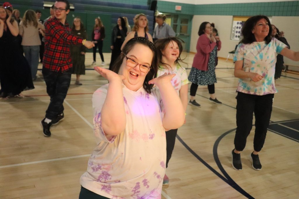 Student poses for a photo while taking part in a school dance.
