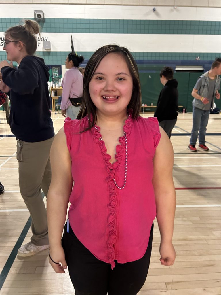 Student poses for a photo at a school dance.