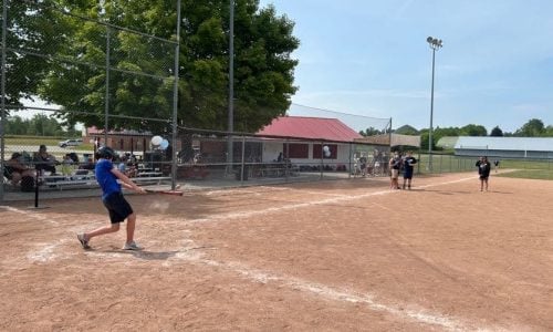 Child hits a baseball during a game.