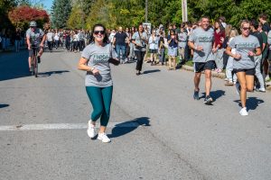 Runners are met by cheering spectators along the roadside.