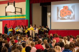 Students in a school gym for an assembly.
