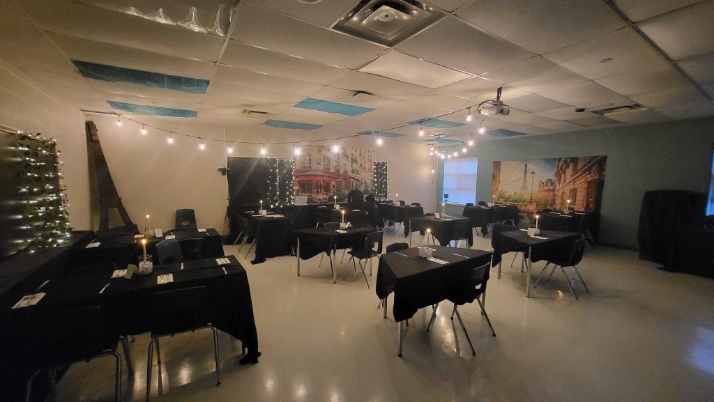 A classroom is transformed into a Parisian cafe complete with decor, lights and music
