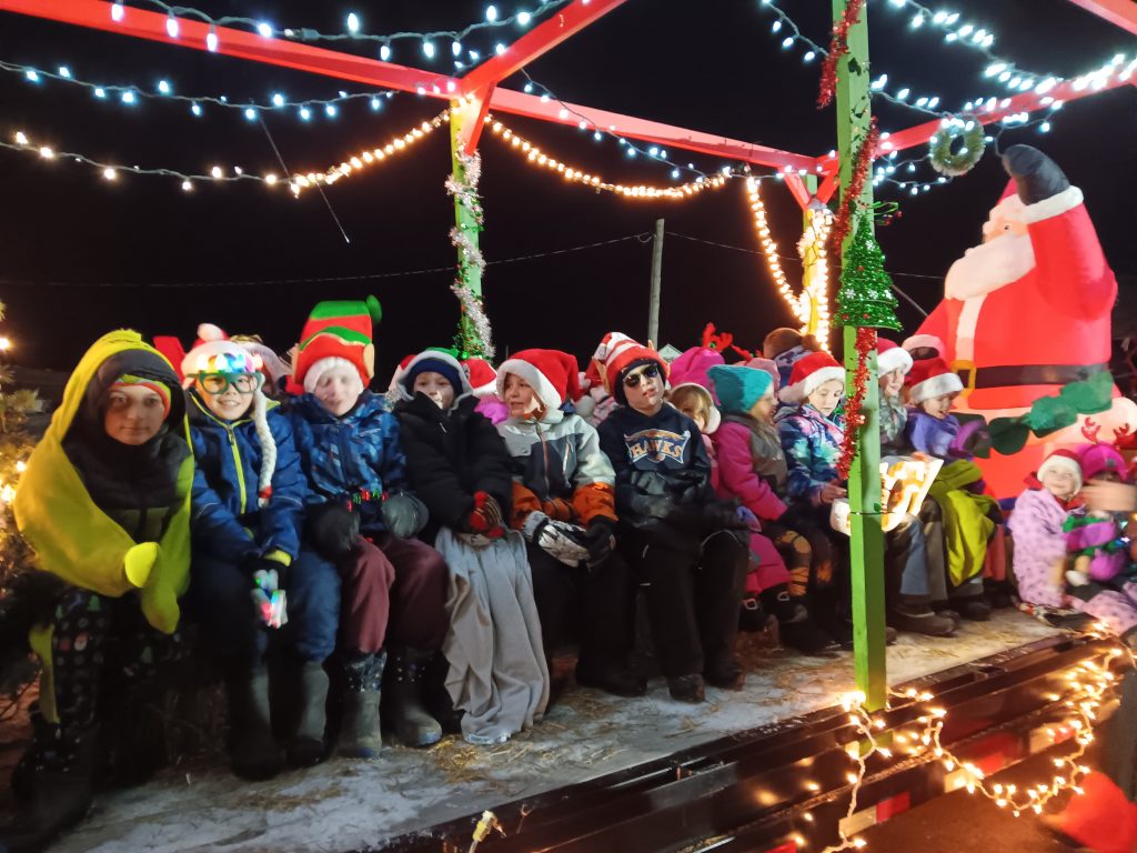 Christmas parade float with students on it.