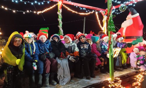 Christmas parade float with students on it.