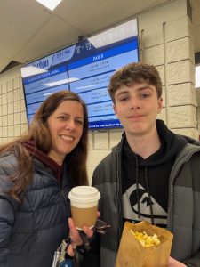 A mother and son enjoy canteen food at an arena.