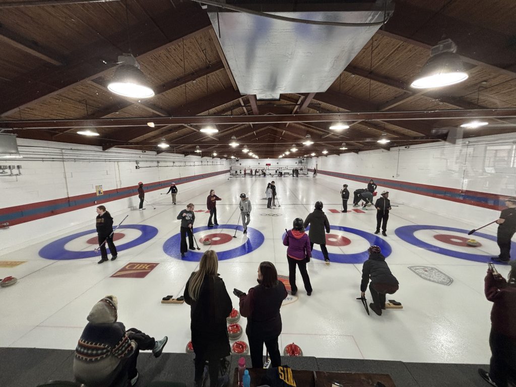 A group of new Canadians tries the sport of curling for the first time.