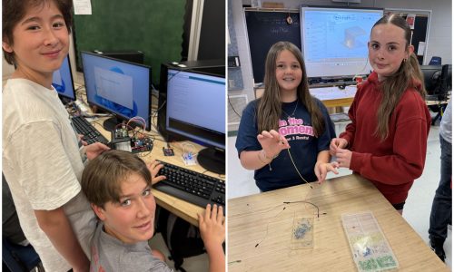 Two male elementary students and two female elementary students try coding in a school lab.