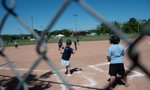 Kids playing baseball.