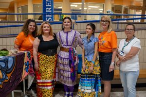 Five women stand together at an Indigenous History Month celebration at a secondary school.